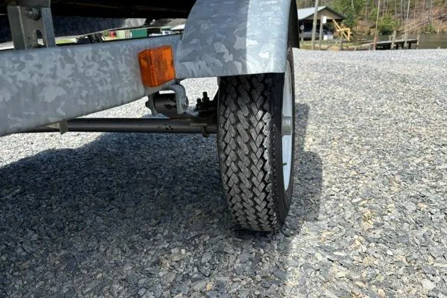 Slide: The Image of Trailer wheel on gravel, part of a 2012 Kawasaki Jetski Ultra LX setup. - 7