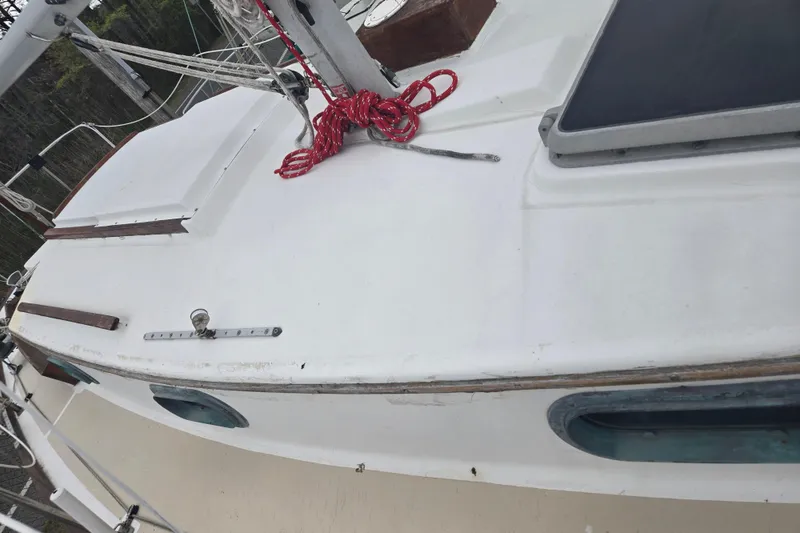 Slide: The Image of 1989 Cape Dory 27 sailboat deck with red rope and hatch. - 12
