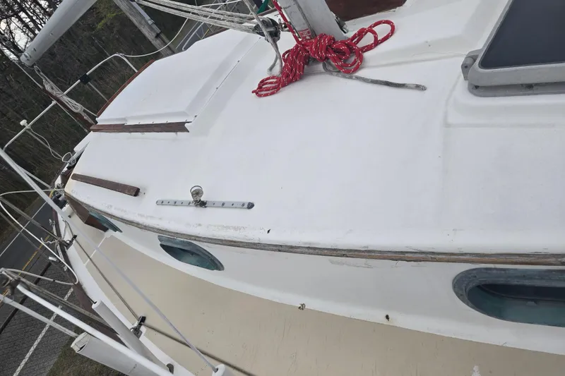 Slide: The Image of 1989 Cape Dory 27 sailboat deck with red rope and hatch details. - 13