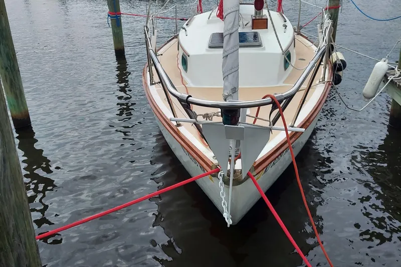 Slide: The Image of 1989 Cape Dory 27 sailboat docked, featuring a classic design and sturdy build. - 3