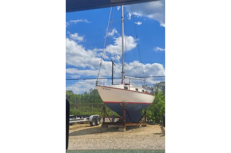 Slide: The Image of 1989 Cape Dory 27 sailboat on trailer under a bright blue sky. - 5