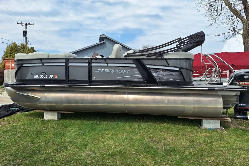 The Image of 2022 Starcraft SLS 1 DL pontoon boat on grass, side view. - 0