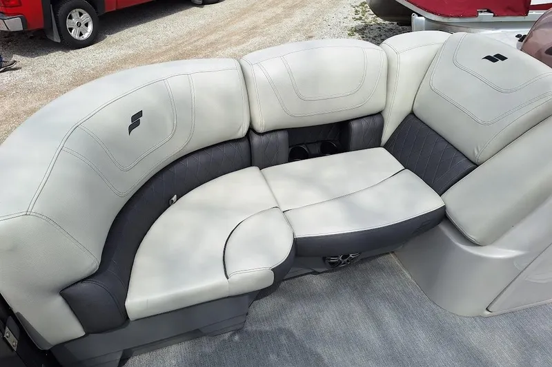 Slide: The Image of 2022 Starcraft SLS 1 DL boat seating with gray and white upholstery, featuring cup holders. - 10