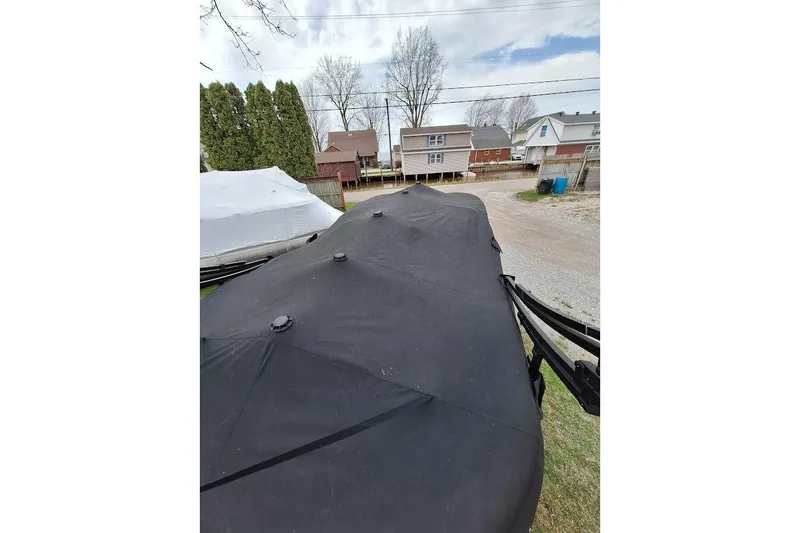 Slide: The Image of Covered 2022 Starcraft SLS 1 DL boat in residential driveway setting. - 14