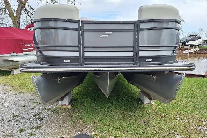 Slide: The Image of 2022 Starcraft SLS 1 DL pontoon boat on grass, front view. - 2