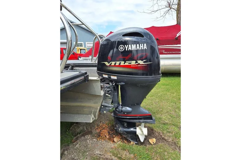 Slide: The Image of Yamaha VMAX outboard motor on a 2022 Starcraft SLS 1 DL boat, parked on grass. - 4