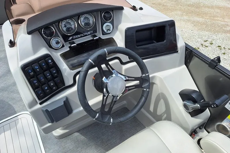 Slide: The Image of 2022 Starcraft SLS 1 DL boat dashboard with steering wheel and control panel. - 5