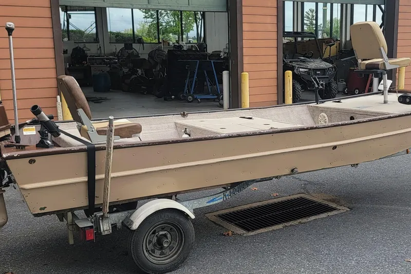 The Image of Small fishing boat on trailer outside a garage, Nova NV JWMV1650SF, 2001 model. - 0