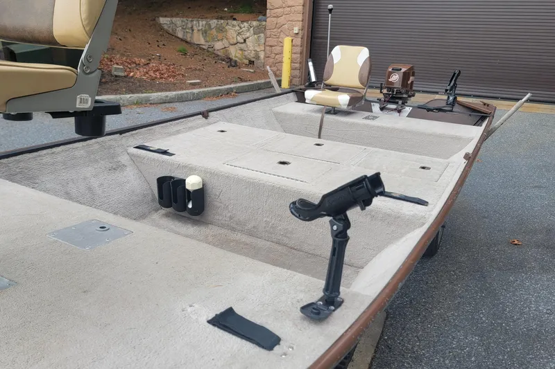 Slide: The Image of 2001 Nova NV JWMV1650SF boat interior with seating and fishing rod holders. - 11