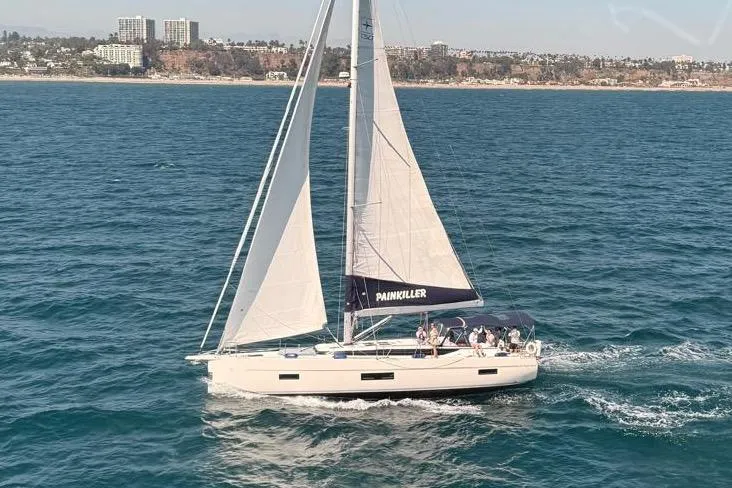 The Image of Sailing yacht Bavaria C50, 2020 model, cruising on the ocean near a coastal city. - 0