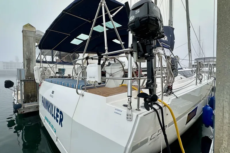 Slide: The Image of 2020 Bavaria C50 yacht docked, featuring a sleek design and outboard motor. - 15