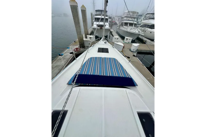 Slide: The Image of 2020 Bavaria C50 yacht docked at marina with striped deck cover. - 18