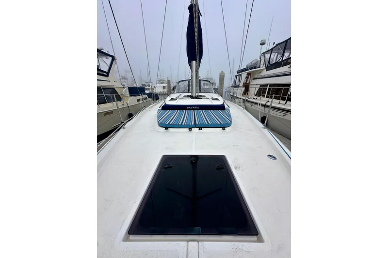Slide: The Image of 2020 Bavaria C50 yacht deck view in marina, surrounded by other boats. - 23
