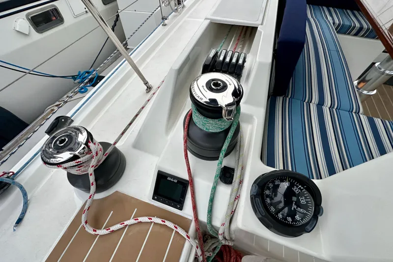 Slide: The Image of Cockpit of 2020 Bavaria C50 sailboat with winches, ropes, and striped seating. - 32