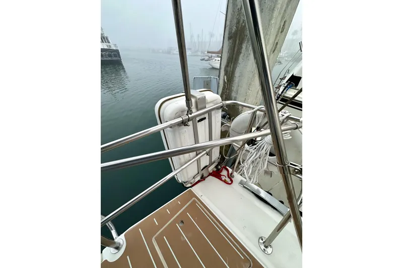 Slide: The Image of Sailboat deck view with railing and equipment, Bavaria C50, 2020 model, in a foggy marina. - 33