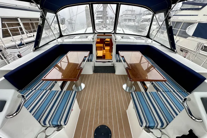 Slide: The Image of Spacious cockpit of 2020 Bavaria C50 yacht with striped seating and wooden tables. - 40