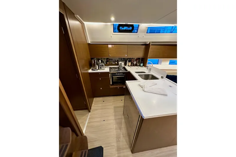 Slide: The Image of Modern kitchen interior of 2020 Bavaria C50 yacht with wooden cabinets and sleek countertops. - 47