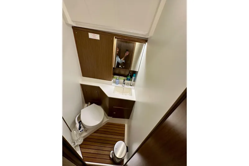 Slide: The Image of 2020 Bavaria C50 yacht bathroom with modern fixtures and wooden accents. - 52