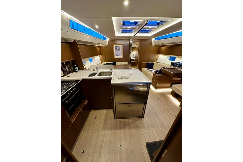 Slide: The Image of Luxurious interior of a 2020 Bavaria C50 yacht with modern kitchen and seating area. - 53