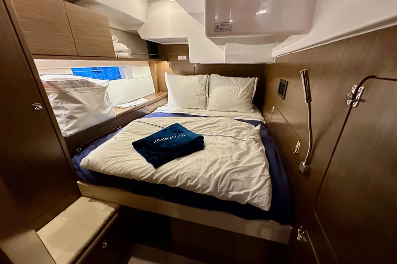 Slide: The Image of Cozy cabin interior of 2020 Bavaria C50 yacht with neatly arranged bed and wooden finish. - 58