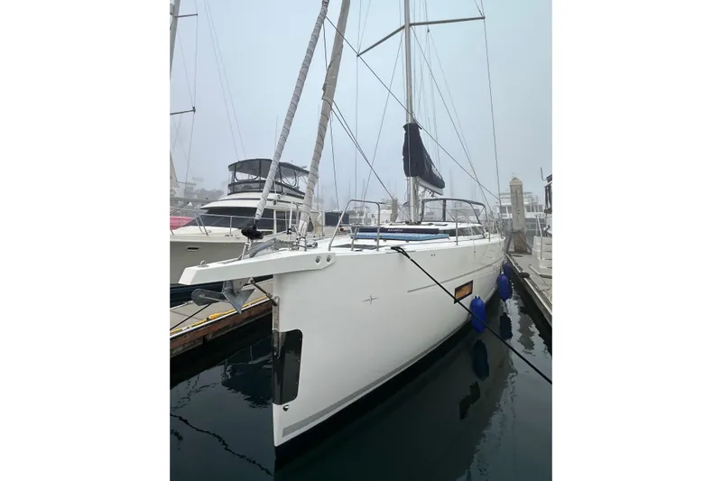 Slide: The Image of 2020 Bavaria C50 yacht docked in a foggy marina, featuring sleek design and modern amenities. - 6