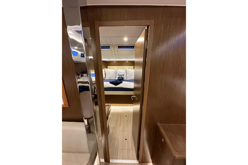 Slide: The Image of Interior view of 2020 Bavaria C50 yacht cabin with cozy bed and wooden finish. - 68