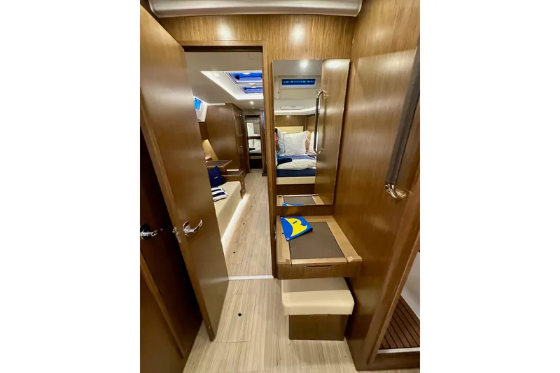 Slide: The Image of Interior of 2020 Bavaria C50 yacht, featuring wooden finishes and cozy cabin space. - 75