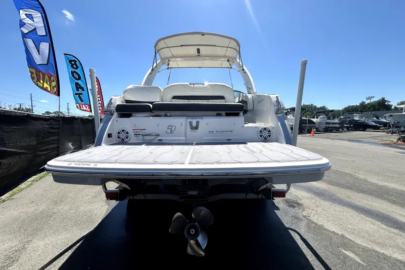 Slide: The Image of 2021 Regal 26 FasDeck boat displayed at a sales event under clear blue skies. - 10