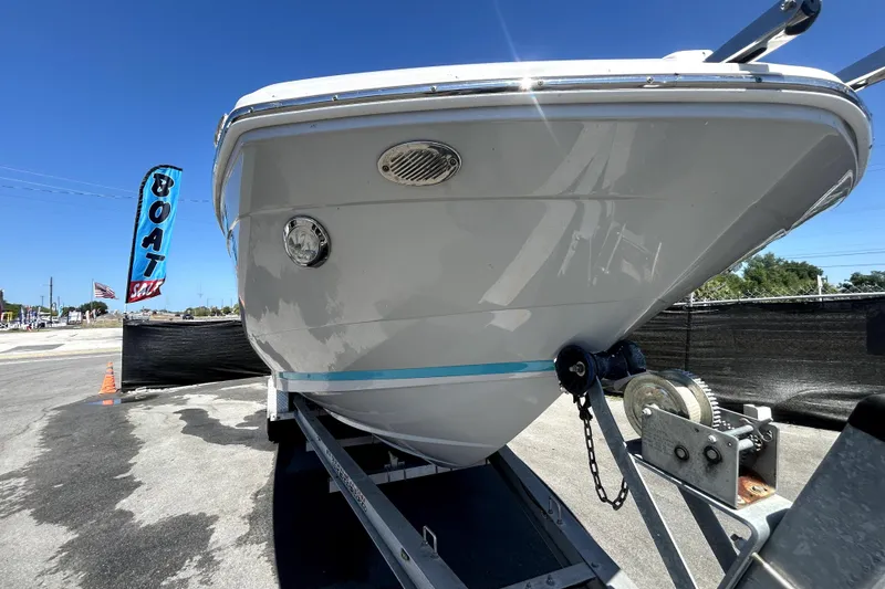 Slide: The Image of 2021 Regal 26 FasDeck boat on trailer at sale location under clear blue sky. - 13