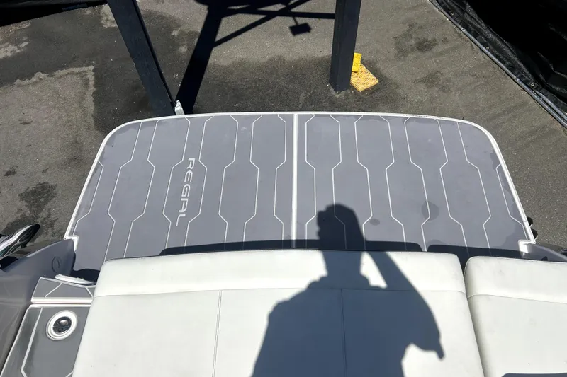 Slide: The Image of Rear deck of 2021 Regal 26 FasDeck boat with shadow and logo visible. - 17