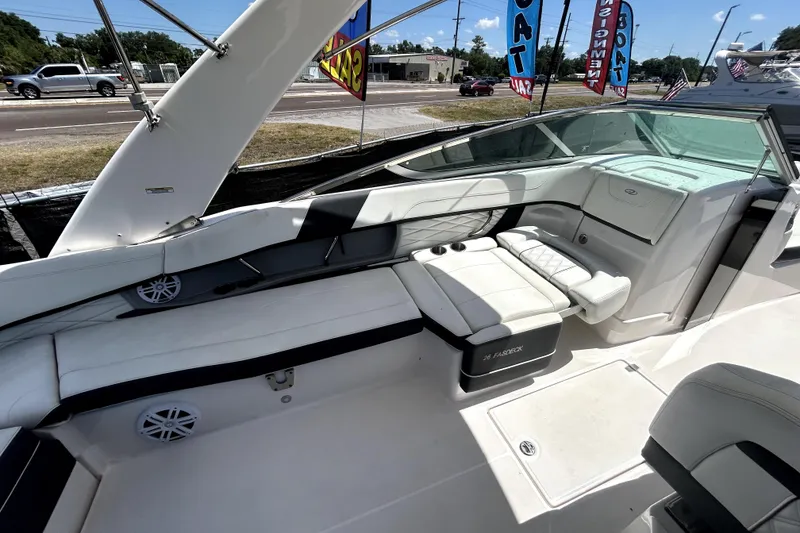 Slide: The Image of 2021 Regal 26 FasDeck boat interior with white seating and modern design. - 21