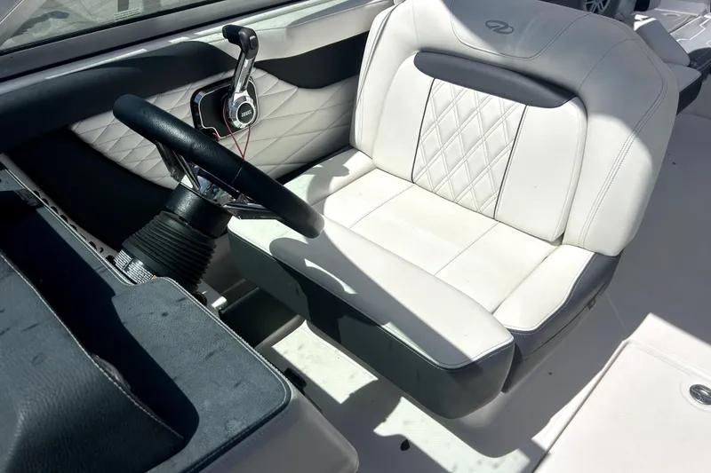 Slide: The Image of 2021 Regal 26 FasDeck boat interior with white leather seating and steering wheel. - 22