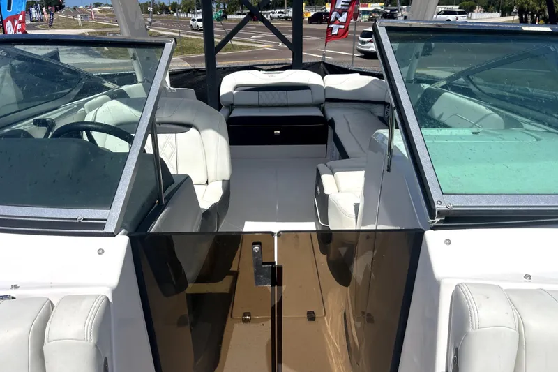 Slide: The Image of 2021 Regal 26 FasDeck boat interior with white seating and dual windshields. - 23