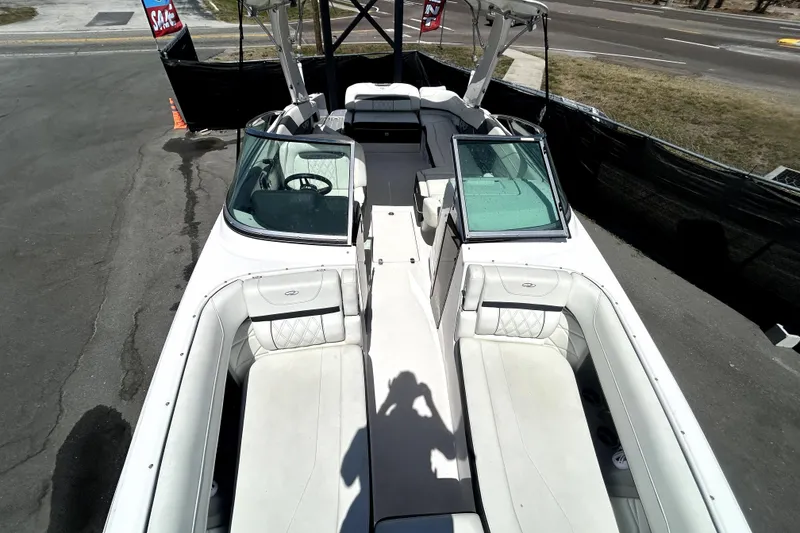 Slide: The Image of 2021 Regal 26 FasDeck boat with spacious seating and sleek design, parked outdoors. - 26