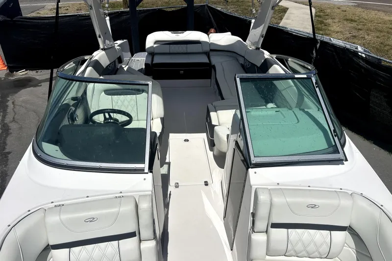 Slide: The Image of 2021 Regal 26 FasDeck boat interior with white seating and open cockpit design. - 29
