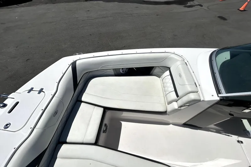 Slide: The Image of 2021 Regal 26 FasDeck boat interior with white cushioned seating and sleek design. - 31