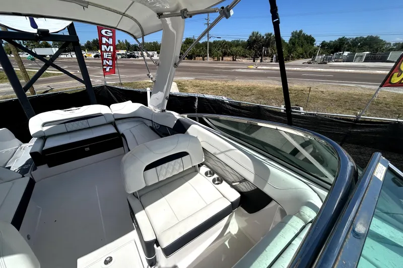 Slide: The Image of 2021 Regal 26 FasDeck boat interior with white seating and open deck view. - 33