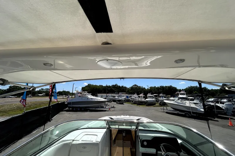 Slide: The Image of 2021 Regal 26 FasDeck boat interior view at a marina with multiple boats. - 36