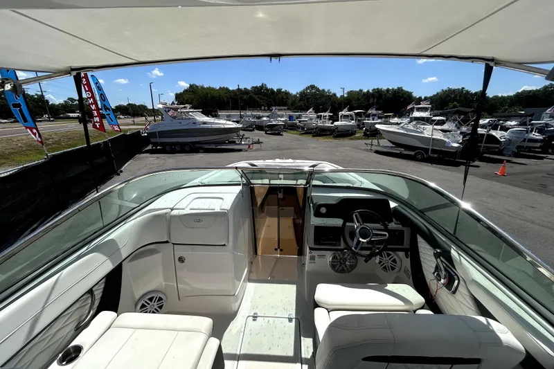 Slide: The Image of 2021 Regal 26 FasDeck boat interior at a dealership, surrounded by other boats. - 37