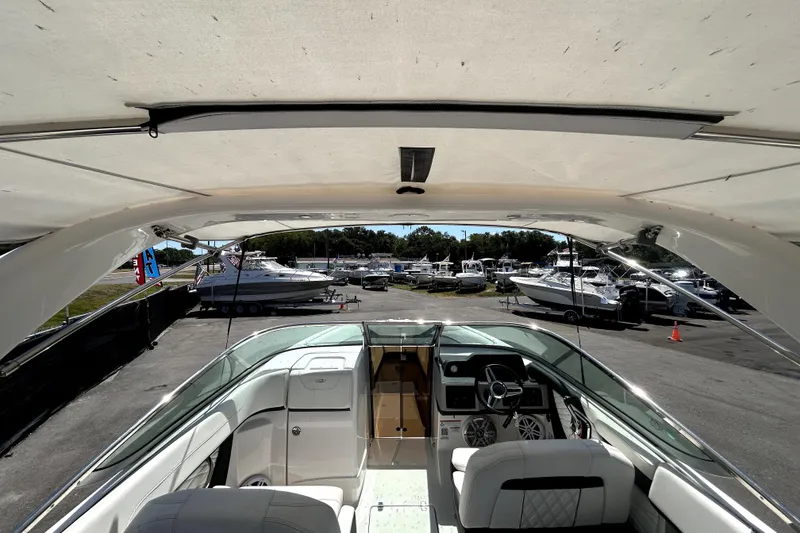 Slide: The Image of 2021 Regal 26 FasDeck boat interior view at a marina with multiple boats. - 38