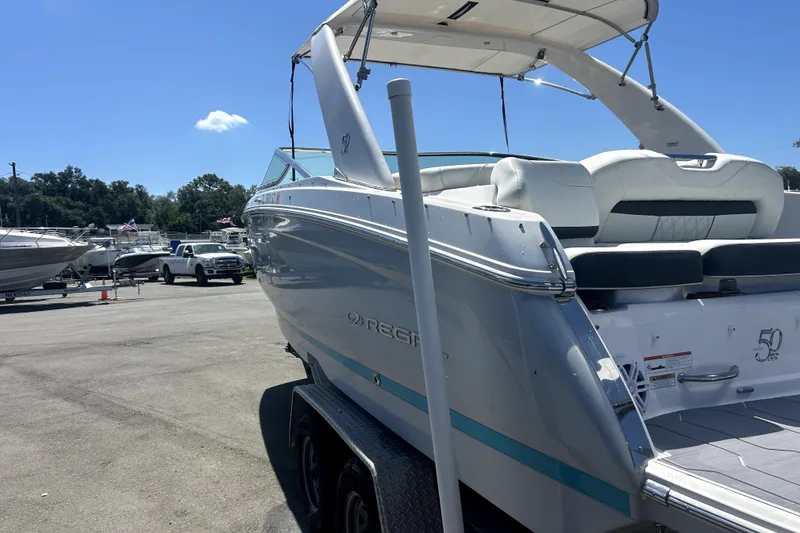 Slide: The Image of 2021 Regal 26 FasDeck boat on trailer in sunny outdoor setting. - 43