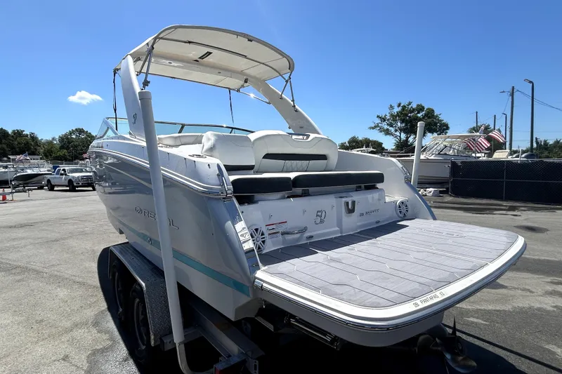 Slide: The Image of 2021 Regal 26 FasDeck boat on trailer, featuring spacious deck and sleek design. - 44
