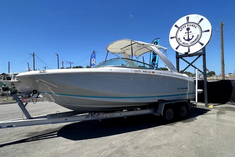 Slide: The Image of 2021 Regal 26 FasDeck boat on trailer at dealership under clear blue sky. - 45