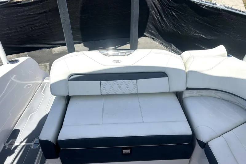 Slide: The Image of 2021 Regal 26 FasDeck boat interior with white cushioned seating. - 48