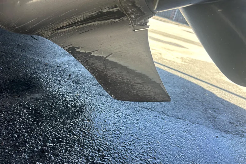 Slide: The Image of Close-up of a 2021 Regal 26 FasDeck boat propeller on wet pavement. - 5