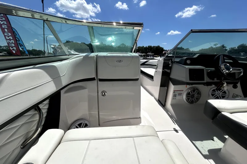 Slide: The Image of Interior view of a 2021 Regal 26 FasDeck boat under a clear blue sky. - 53