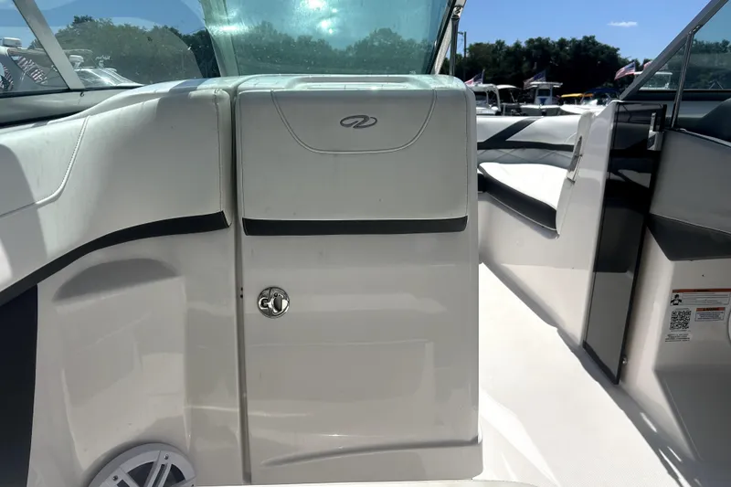 Slide: The Image of Interior view of a 2021 Regal 26 FasDeck boat, featuring sleek white design. - 54