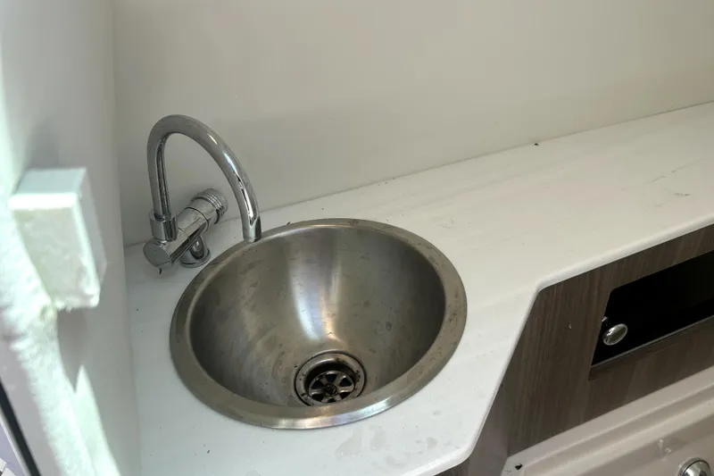 Slide: The Image of Stainless steel sink in 2021 Regal 26 FasDeck boat interior. - 56