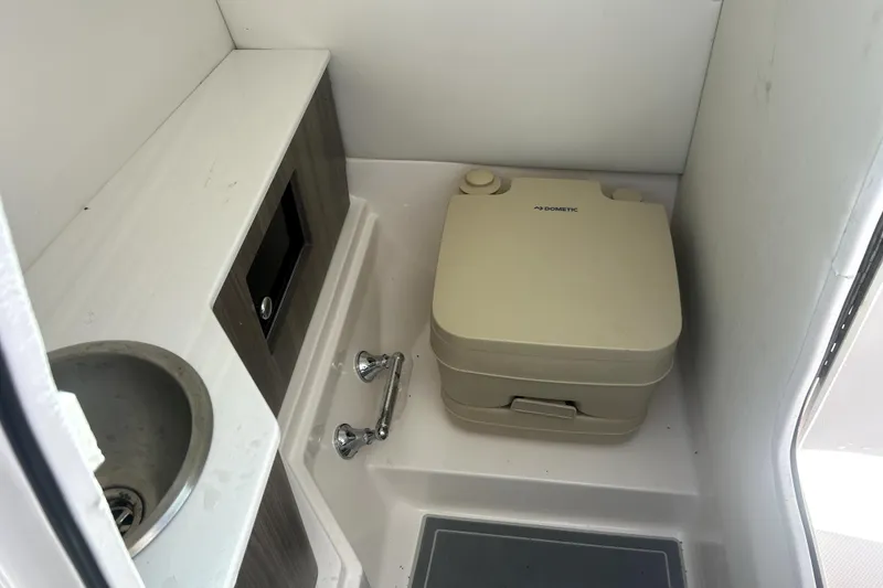 Slide: The Image of Compact bathroom in 2021 Regal 26 FasDeck boat with sink and portable toilet. - 57