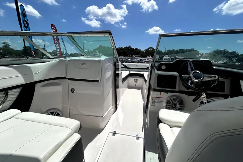 Slide: The Image of Interior view of a 2021 Regal 26 FasDeck boat under a clear blue sky. - 59